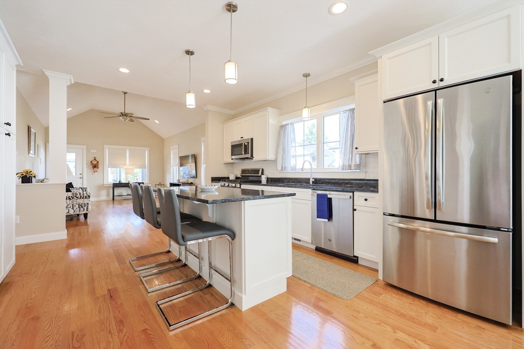 47 Compass Point Drive, Unit 47 Douglas, MA 01516 - Photo 9 of 32 a kitchen with stainless steel appliances granite countertop a refrigerator a sink dishwasher a stove and white cabinets with wooden floor