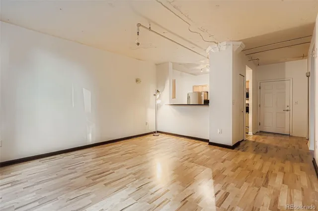 a view of a room with wooden floor and white walls