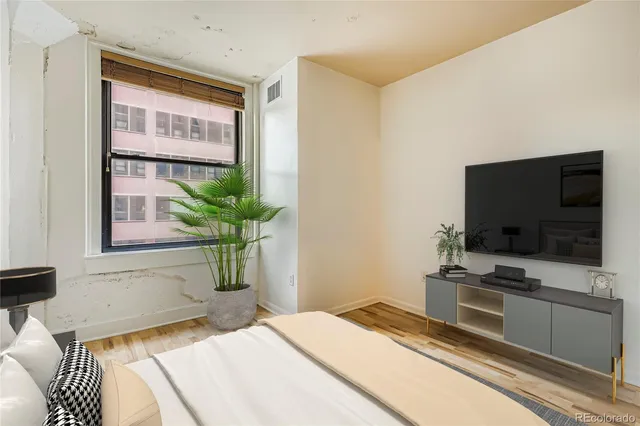 a bedroom with a bed and a television