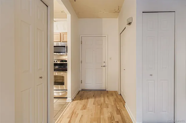 a view of a bedroom with wooden floor and closet