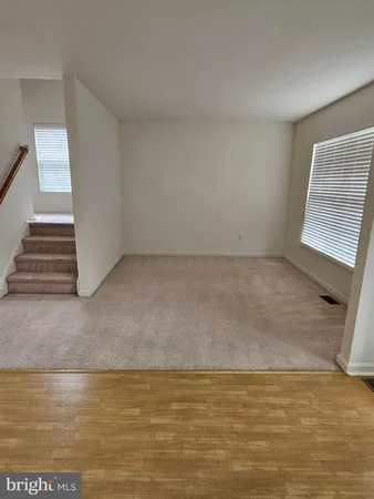 a view of a livingroom with an empty space and a window