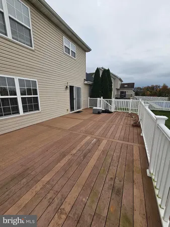 a balcony with wooden floor and outdoor space