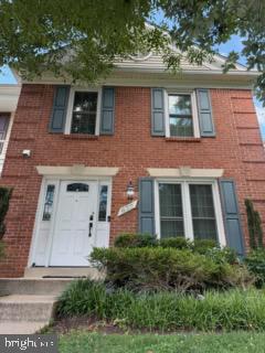 Charming brick facade with classic shutters.