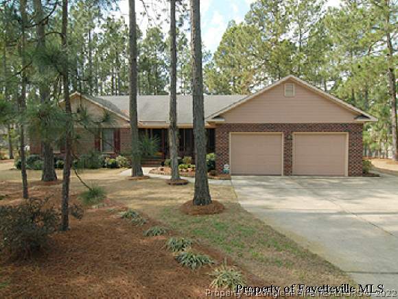7775 Dragonhead Road Fayetteville, NC 28311 - Photo 1 of 12 a house with trees in the background