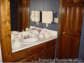 7775 Dragonhead Road Fayetteville, NC 28311 - Photo 12 of 12 a bathroom with a sink and a mirror