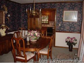 7775 Dragonhead Road Fayetteville, NC 28311 - Photo 7 of 12 a view of a dining room with furniture and chandelier