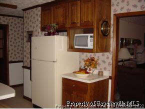 7775 Dragonhead Road Fayetteville, NC 28311 - Photo 9 of 12 a kitchen with a refrigerator and a stove
