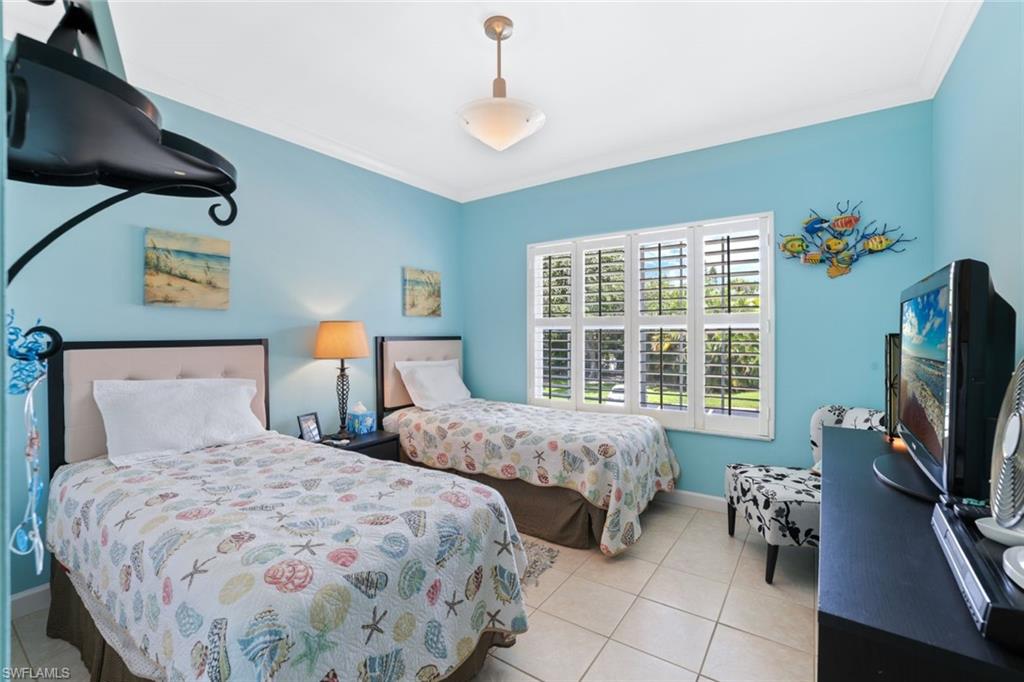 3047 Horizon Lane, Unit 1908 Naples, FL 34109 - Photo 12 of 17 Tiled bedroom featuring ornamental molding