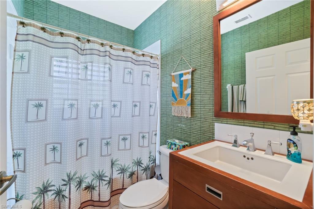 3047 Horizon Lane, Unit 1908 Naples, FL 34109 - Photo 13 of 17 Bathroom with a shower with curtain, toilet, and vanity