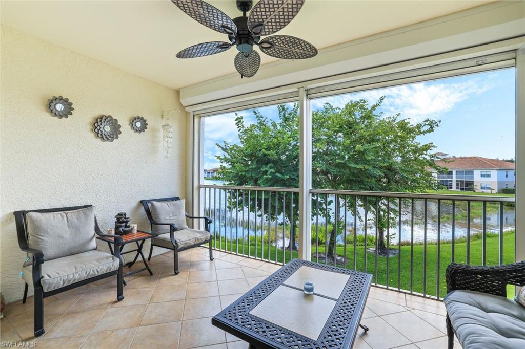 3047 Horizon Lane, Unit 1908 Naples, FL 34109 - Photo 16 of 17 Sunroom / solarium featuring a water view and ceiling fan