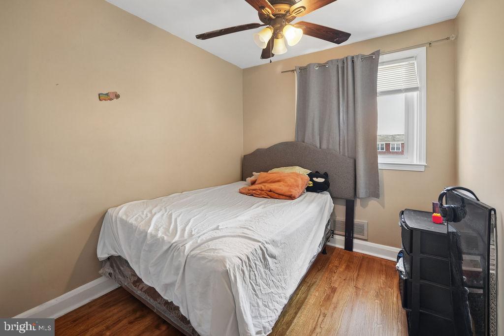 1918 Church Road Baltimore, MD 21222 - Photo 17 of 29 a bedroom with a bed and a chandelier
