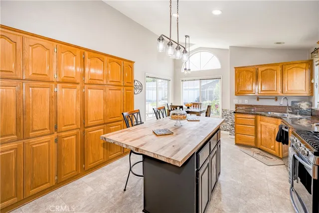 a kitchen with stainless steel appliances granite countertop a sink and a refrigerator