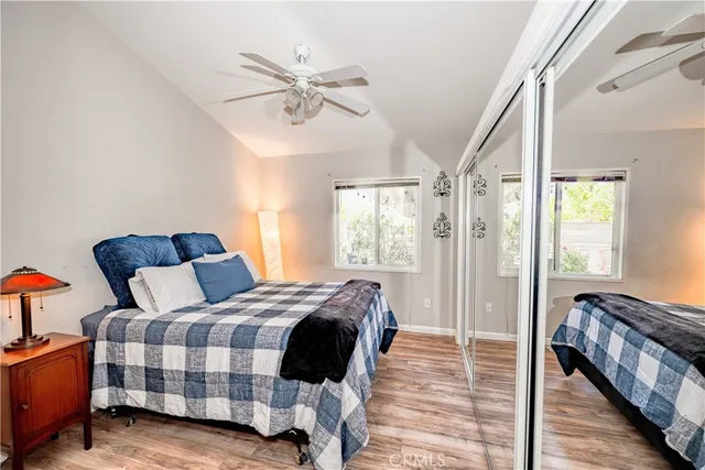 a bedroom with a bed and wooden floor