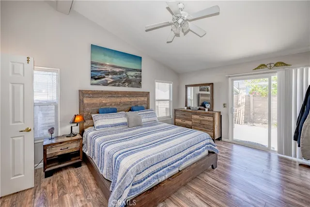 a bedroom with a large bed a chandelier and a window