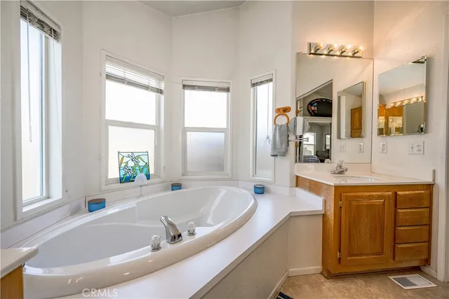 a spacious bathroom with sink shower and bathtub