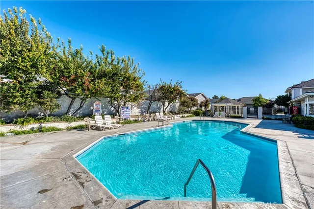 a swimming pool with outdoor seating and yard