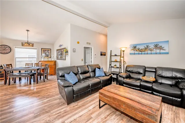 a living room with furniture kitchen view and a dining table