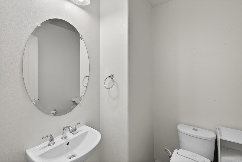 31554 Alicante Loop Winchester, CA 92596 - Photo 11 of 34 a bathroom with a toilet sink and mirror