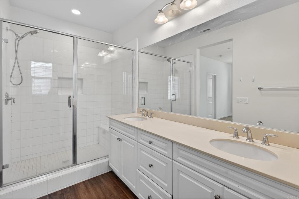 31554 Alicante Loop Winchester, CA 92596 - Photo 18 of 34 a bathroom with a double vanity sink mirror and shower