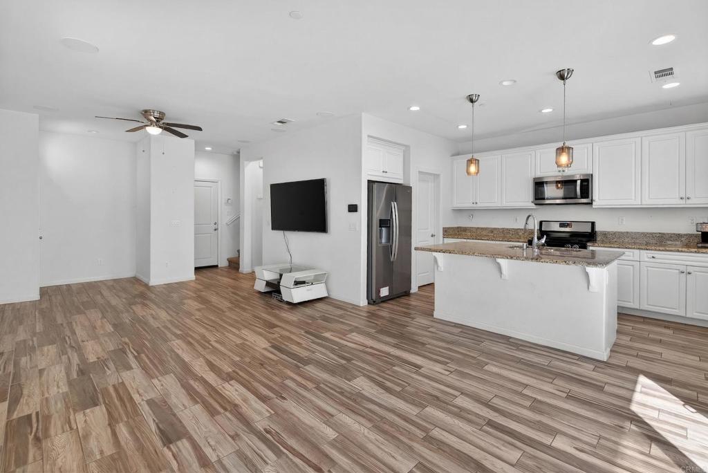 31554 Alicante Loop Winchester, CA 92596 - Photo 5 of 34 a view of kitchen with sink microwave and refrigerator