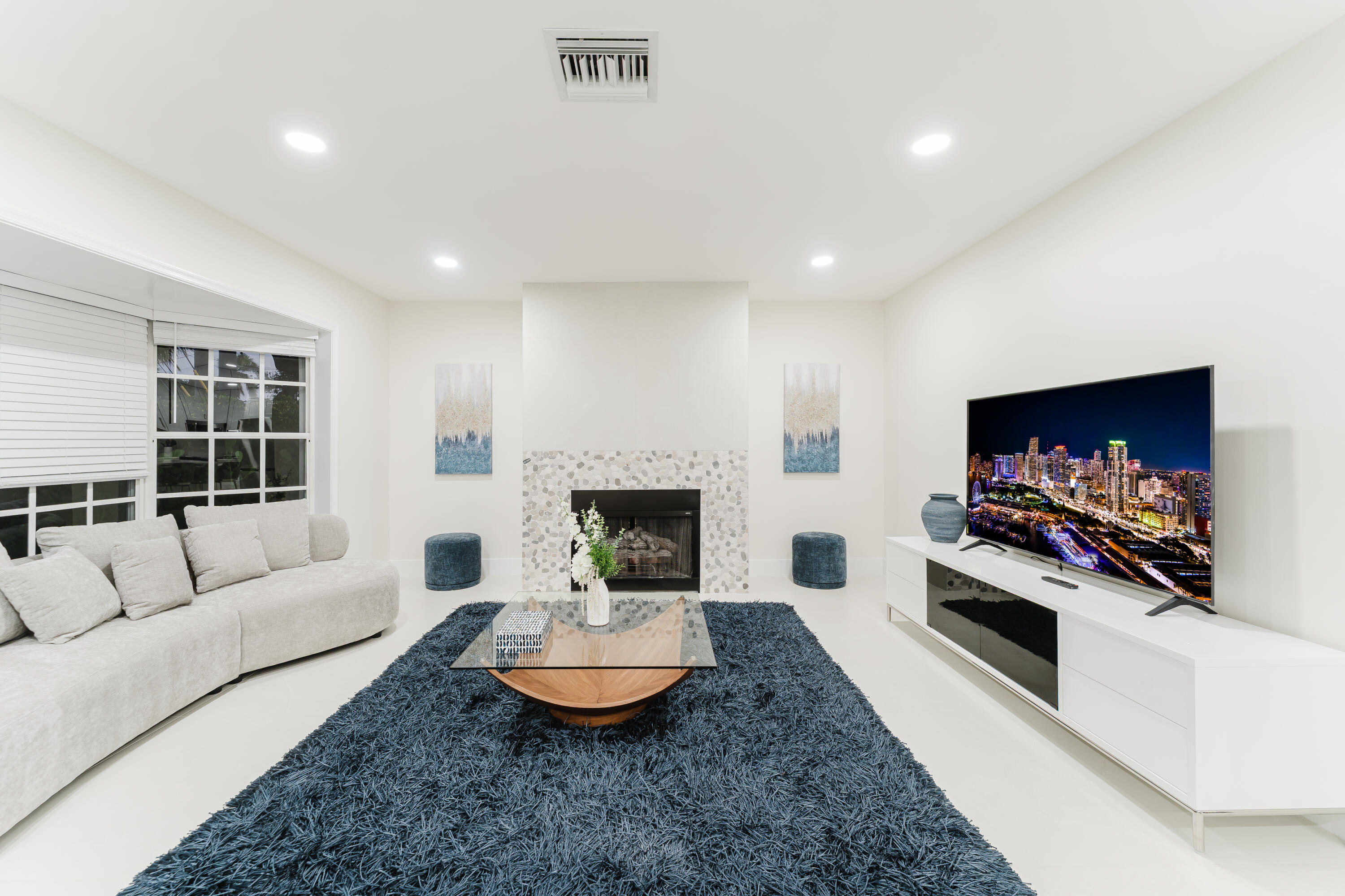 3199 Northeast 6th Drive Boca Raton, FL 33431 - Photo 2 of 49 a living room with furniture and a flat screen tv