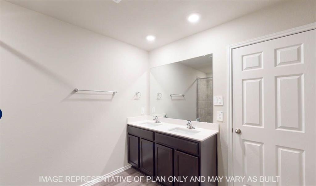 10204 Neptune Court Waco, TX 76708 - Photo 15 of 20 Double vanity with dark wood-finish cabinetry, white countertop, and integrated sinks