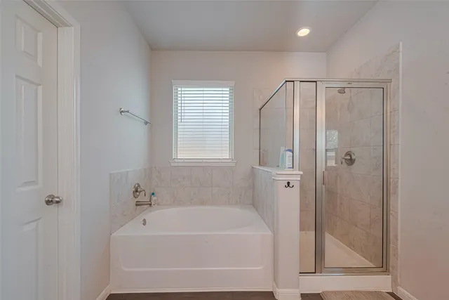 a bathroom with a bathtub and a shower