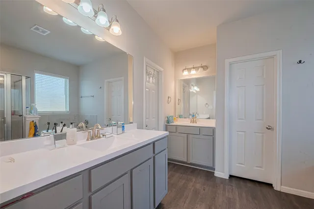 a bathroom with a double vanity sink and a mirror