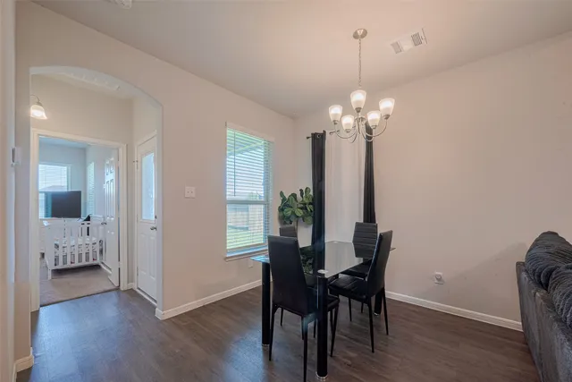 a view of a dining room with furniture wooden floor and chandelier