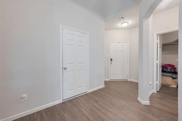 a view of an empty room and wooden floor