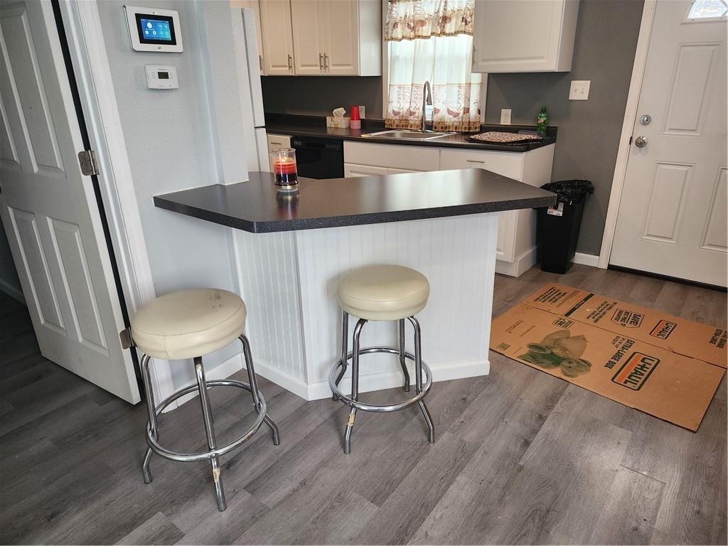 701 Jackson Road Apollo, PA 15613 - Photo 12 of 33 a kitchen with stainless steel appliances granite countertop a stove a refrigerator a sink a dining table and chairs with wooden floor