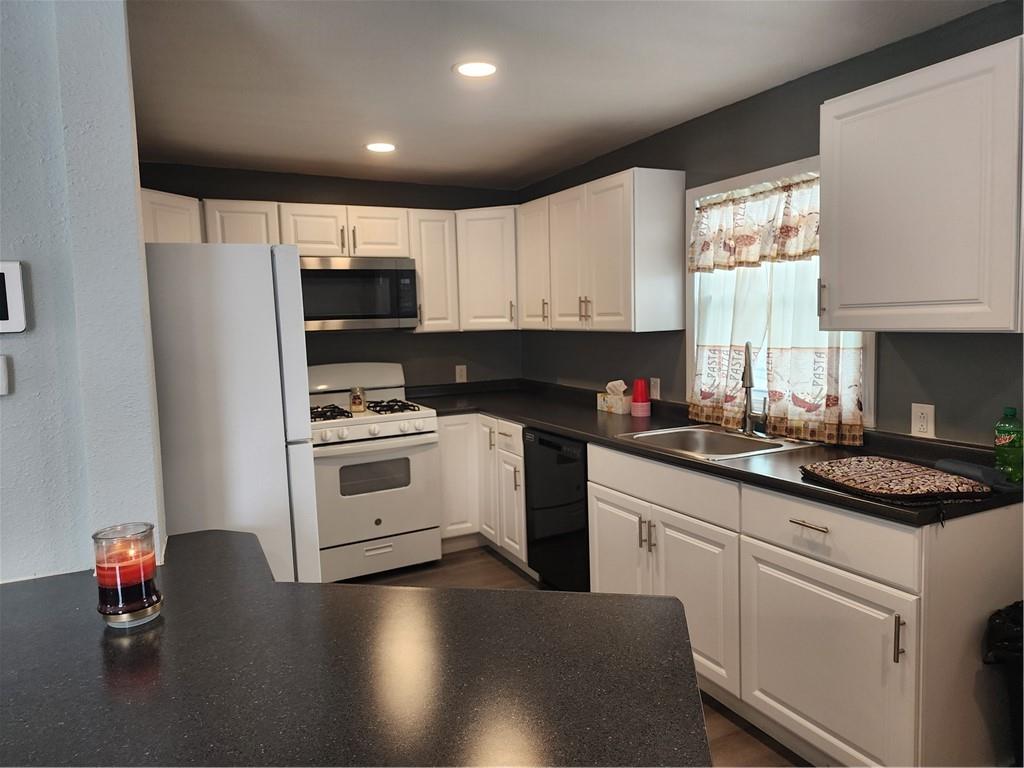701 Jackson Road Apollo, PA 15613 - Photo 13 of 33 a kitchen with stainless steel appliances granite countertop a stove a sink dishwasher a refrigerator and white cabinets with wooden floor