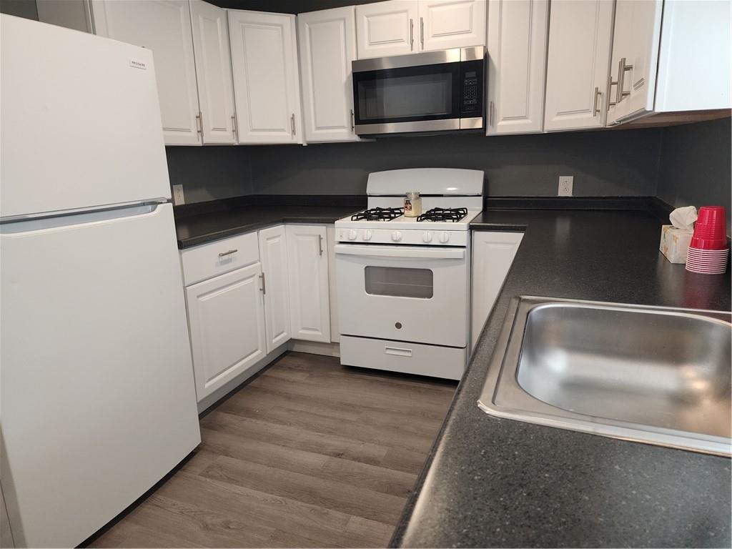 701 Jackson Road Apollo, PA 15613 - Photo 9 of 33 a kitchen with white cabinets and black appliances