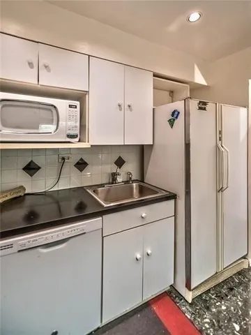 a kitchen with stainless steel appliances a cabinets and a refrigerator