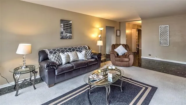 a living room with furniture and a lamp