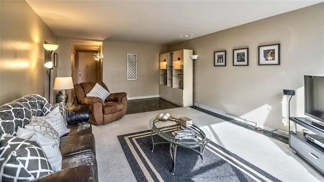a view of a livingroom with furniture and a flat screen tv