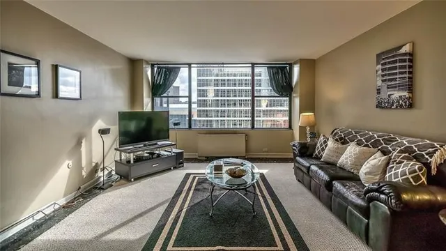 a bedroom with furniture and a flat screen tv