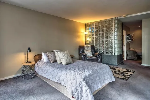 a bedroom with furniture and a large window