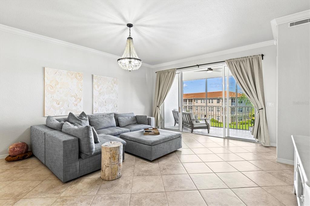 1000 San Lino Circle, Unit 1032 Venice, FL 34292 - Photo 17 of 88 a living room with furniture and a floor to ceiling window