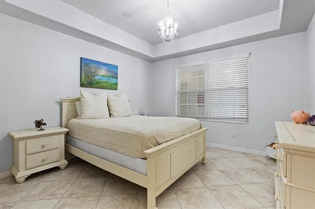 a bedroom with a bed and a chandelier