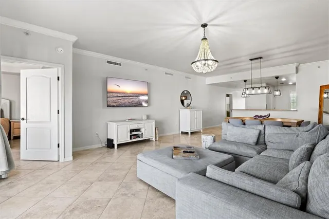 a spacious bedroom with a bed and a chandelier