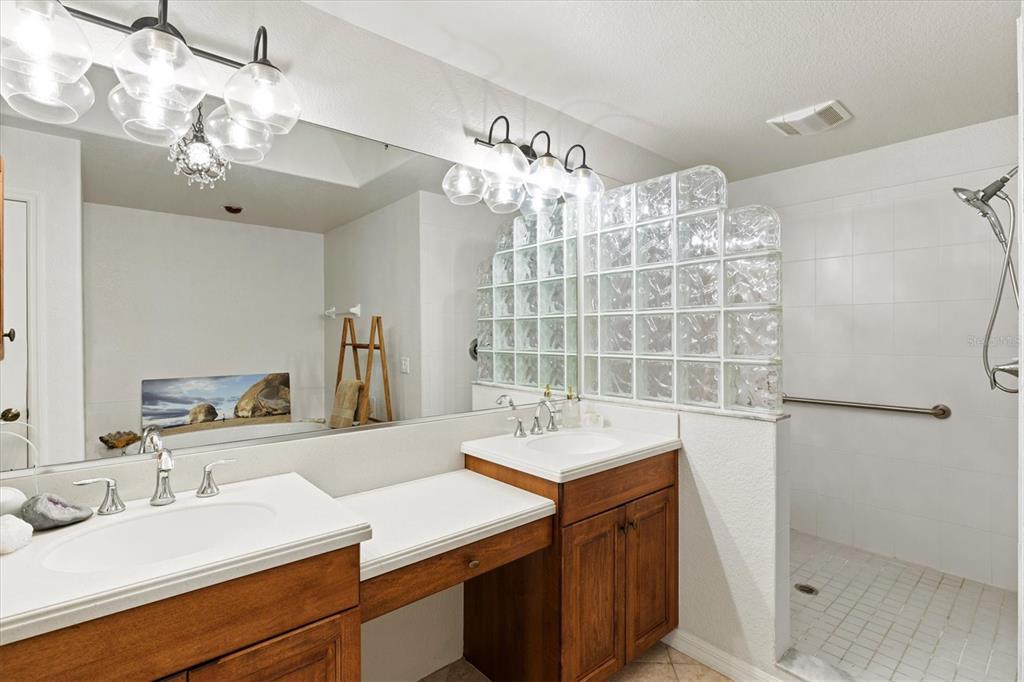 1000 San Lino Circle, Unit 1032 Venice, FL 34292 - Photo 32 of 88 a bathroom with a sink double vanity and a mirror