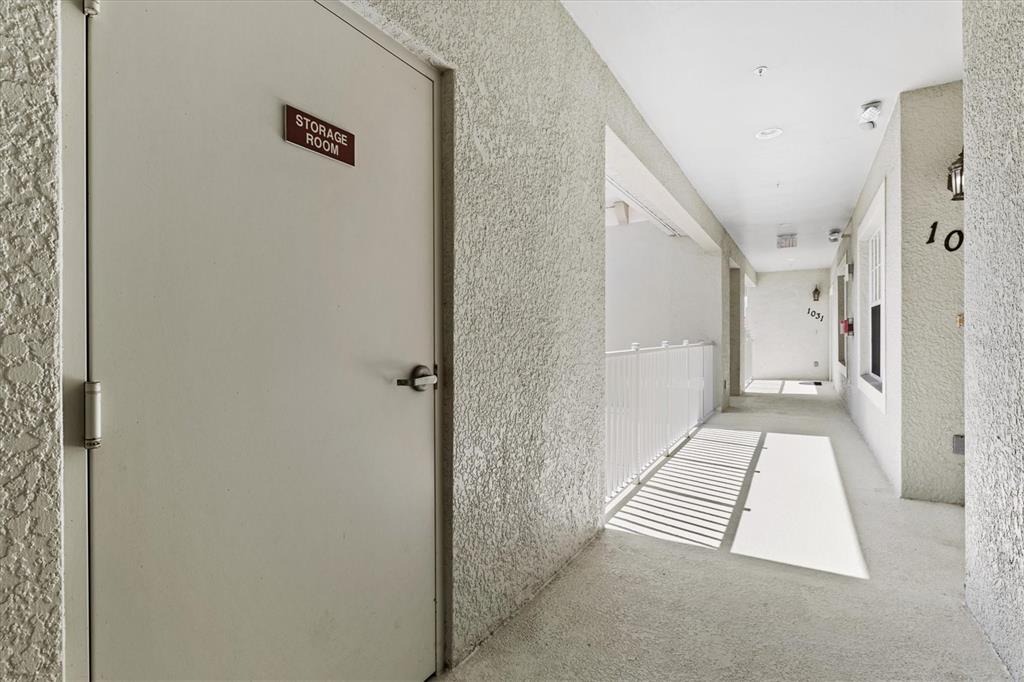 1000 San Lino Circle, Unit 1032 Venice, FL 34292 - Photo 40 of 88 a view of a hallway with wooden floor and a living room