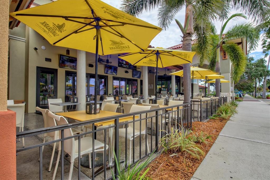 1000 San Lino Circle, Unit 1032 Venice, FL 34292 - Photo 74 of 88 a view of a patio with a table and chairs under an umbrella