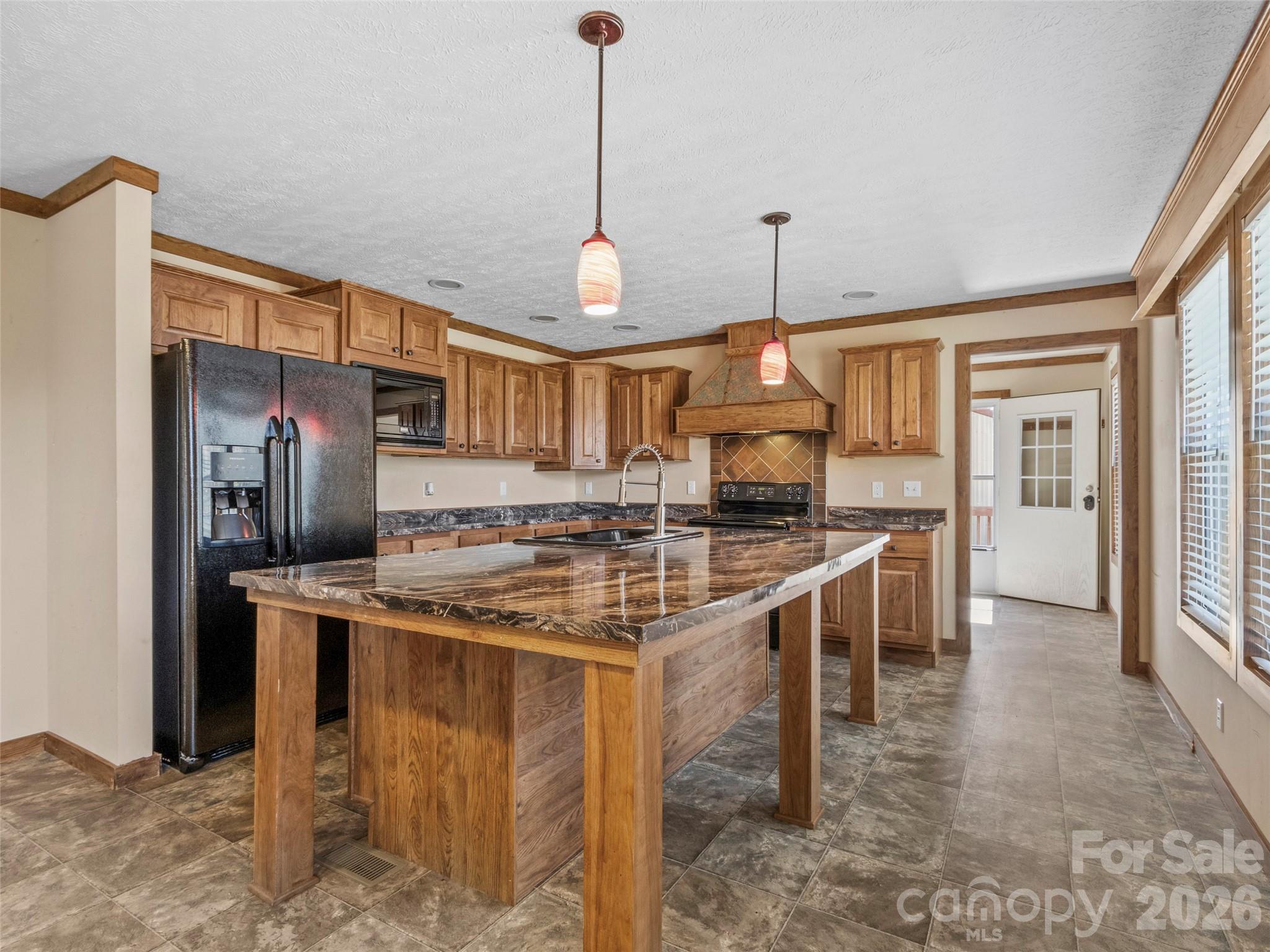 695 Johnson Farm Road Canton, NC 28716 - Photo 13 of 37 a kitchen with stainless steel appliances granite countertop a stove and a refrigerator
