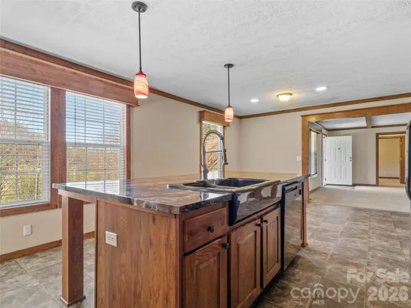 a kitchen with stainless steel appliances granite countertop a stove a sink and a wooden floors