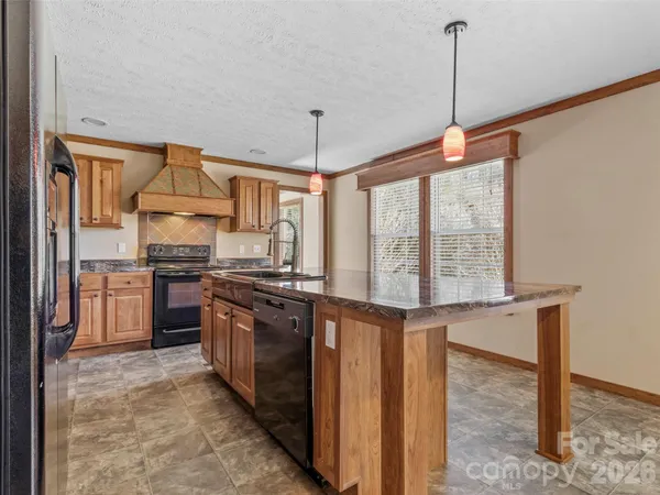 a kitchen with stainless steel appliances granite countertop a stove and a sink