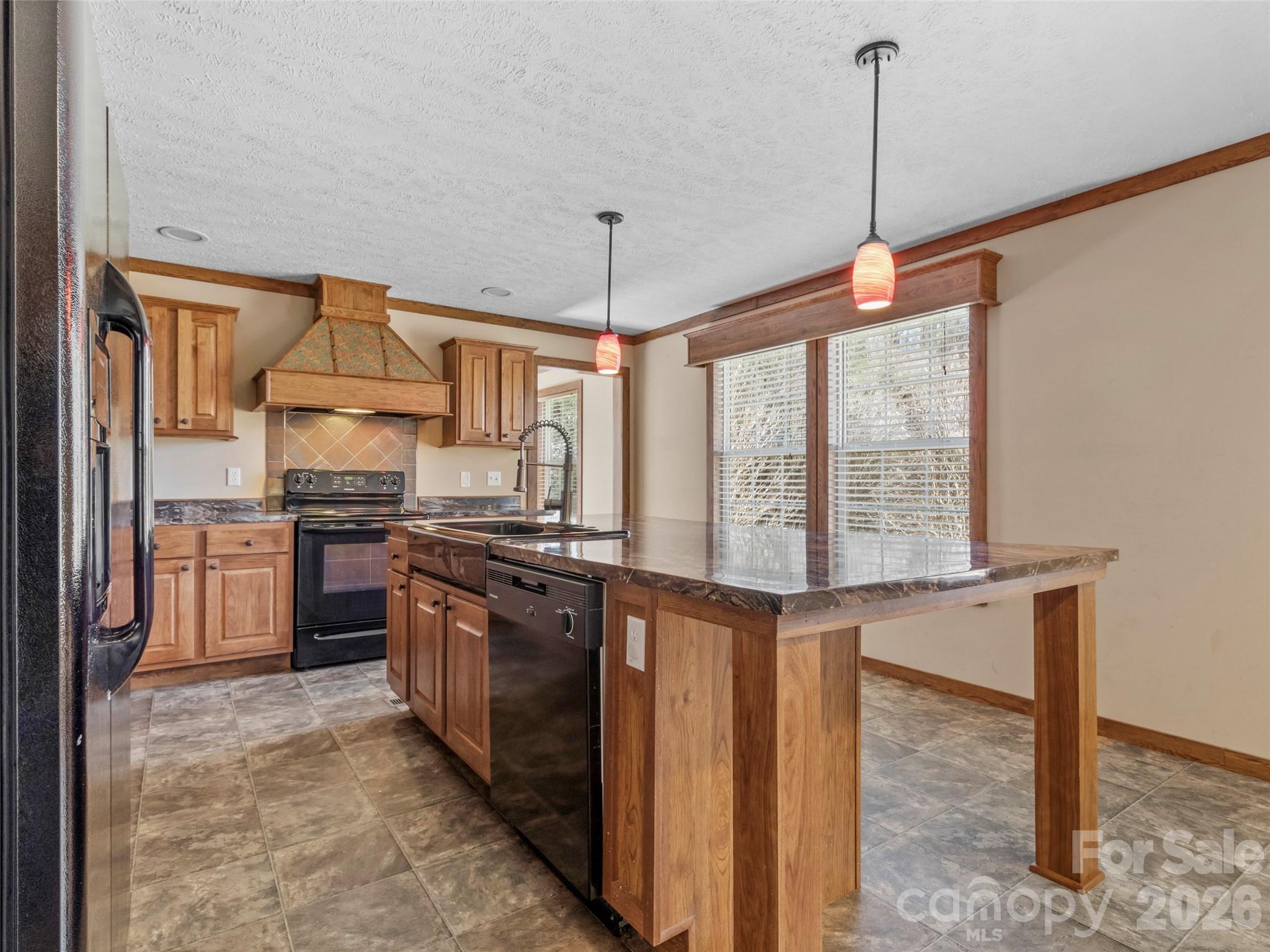 695 Johnson Farm Road Canton, NC 28716 - Photo 16 of 37 a kitchen with stainless steel appliances granite countertop a stove and a sink