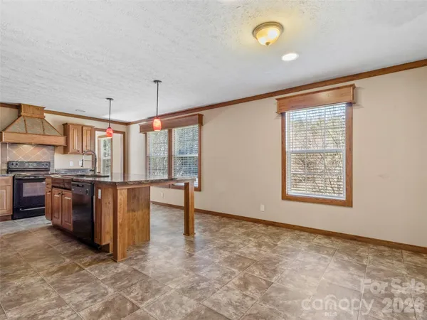 a view of workspace with kitchen island furniture and windows