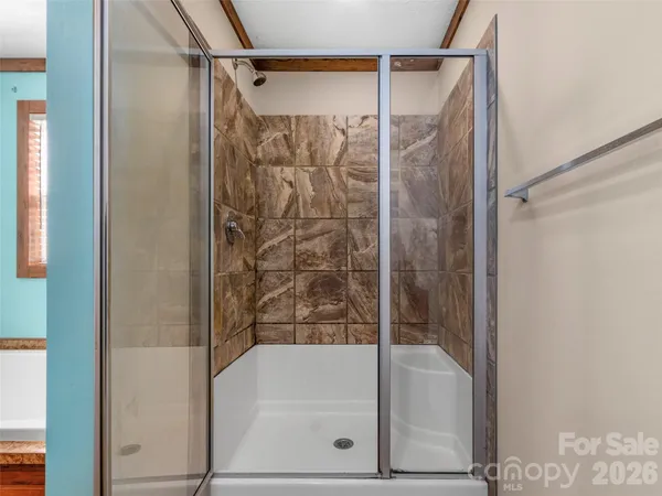 a bathroom with a bathtub and a shower